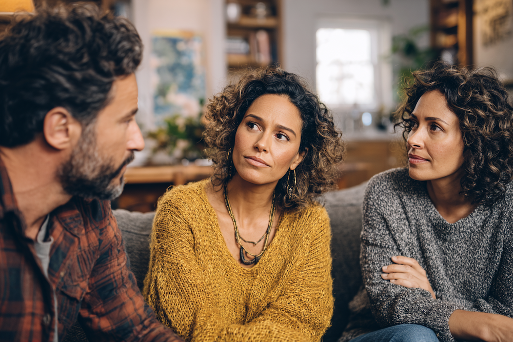 Overwhelmed siblings experiencing family digital caregiver burden while helping elderly parent