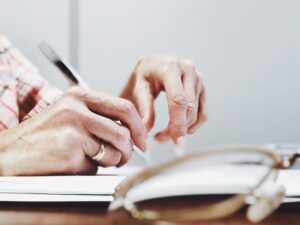 Elderly person managing online banking accounts on mobile device