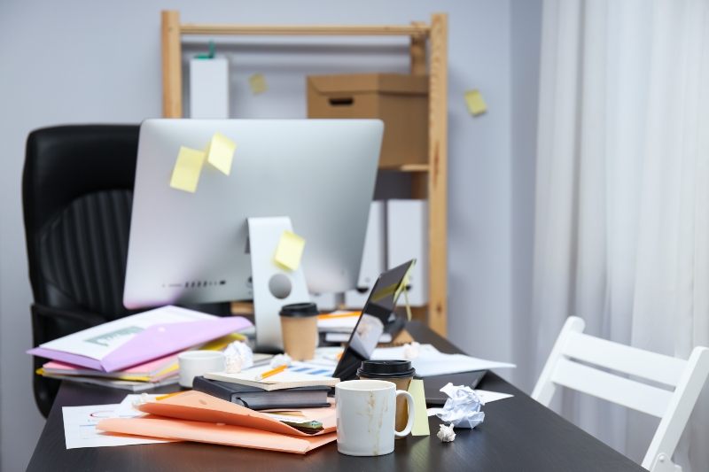 Cluttered desk representing digital hoarding psychology and organization challenges