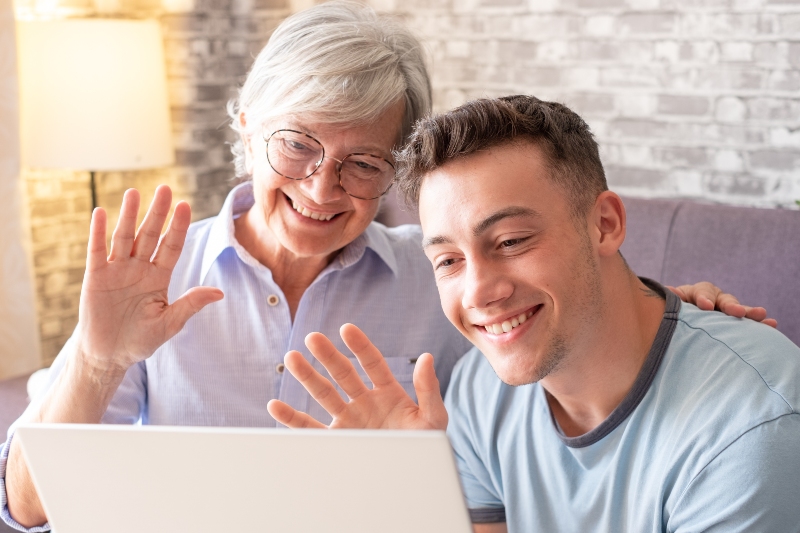 Elderly woman and adult son having video call conversation