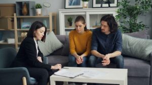 Three adult siblings discussing estate planning to resolve family conflicts